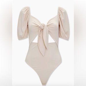 Ribbed cutout bodysuit with puff sleeve.